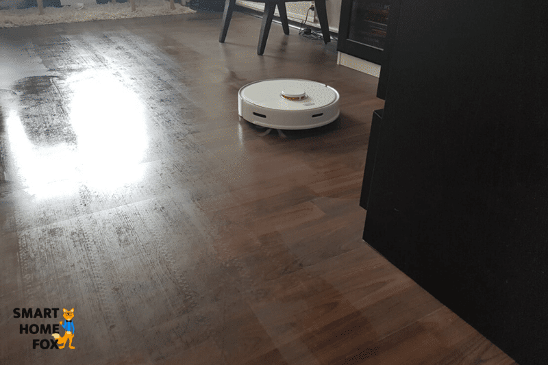 A vacuum-mop robot vacuums and mops the floor at the same time.